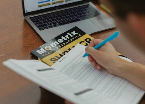 person writing on white paper